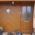 Front door with wood paneling.